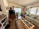 Cozy living room with comfortable seating, natural light, and a seamless connection to the outdoor patio at 1616 Lauren Ln, Lady Lake, FL 32159