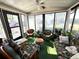 Bright sunroom with floral furniture, offering a relaxing space with natural light and outdoor views at 1616 Lauren Ln, Lady Lake, FL 32159