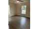This bedroom features a ceiling fan, wood-look flooring and a window providing ample natural light at 16487 Sw 55Th, Ocala, FL 34473