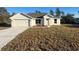 Charming single-story home with attached garage, manicured lawn and newly installed flower bed at 16487 Sw 55Th, Ocala, FL 34473