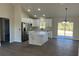 Modern kitchen features stainless steel appliances, white cabinets, and a large center island at 16487 Sw 55Th, Ocala, FL 34473