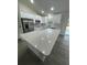 Bright kitchen featuring a quartz countertop island, stainless steel appliances, and modern finishes at 16487 Sw 55Th, Ocala, FL 34473