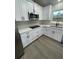 Modern kitchen with white cabinets, stainless steel appliances, and a flat cooktop at 16487 Sw 55Th, Ocala, FL 34473