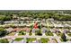 Aerial view of neighborhood showcasing the home's location among mature trees at 17076 Se 96Th Chapelwood Cir, The Villages, FL 32162