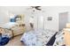 Bedroom features a ceiling fan, neutral decor, and easy access to closet and bathroom at 17076 Se 96Th Chapelwood Cir, The Villages, FL 32162