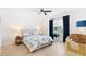 The bedroom features a ceiling fan, neutral decor, and an exterior view at 17076 Se 96Th Chapelwood Cir, The Villages, FL 32162