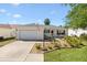 Charming single-story home featuring a well-manicured lawn and an attached one car garage at 17076 Se 96Th Chapelwood Cir, The Villages, FL 32162