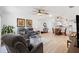 Open-concept living area featuring a ceiling fan and easy access to dining area and kitchen at 17076 Se 96Th Chapelwood Cir, The Villages, FL 32162