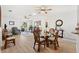 The home's open-concept living and dining room has hardwood flooring at 17076 Se 96Th Chapelwood Cir, The Villages, FL 32162
