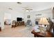 Bright living room features a ceiling fan and a sliding door to the lanai at 17076 Se 96Th Chapelwood Cir, The Villages, FL 32162