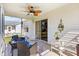 Relaxing screened in patio with comfortable seating and ceiling fan at 17076 Se 96Th Chapelwood Cir, The Villages, FL 32162