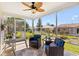 Relaxing screened porch featuring comfortable seating and views of the backyard at 17076 Se 96Th Chapelwood Cir, The Villages, FL 32162