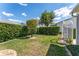 A serene backyard featuring lush greenery, well-trimmed hedges, and decorative landscaping stones for a peaceful retreat at 1709 Betrillo Ct, The Villages, FL 32162