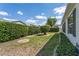 A serene backyard featuring lush greenery, well-trimmed hedges, and decorative landscaping stones for a peaceful retreat at 1709 Betrillo Ct, The Villages, FL 32162