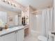 Bathroom featuring white cabinets, countertop space, and a shower-tub combination at 1709 Betrillo Ct, The Villages, FL 32162