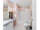 Bathroom with a vanity, mirror, and combination shower and tub with white shower curtain at 1709 Betrillo Ct, The Villages, FL 32162
