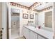 Bright bathroom featuring a walk-in shower, updated vanity, and ample cabinet space at 1709 Betrillo Ct, The Villages, FL 32162