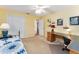 Bright bedroom featuring a desk, carpet floors, and a closet offering generous storage at 1709 Betrillo Ct, The Villages, FL 32162