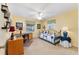 Comfortable bedroom with a ceiling fan, a desk, and a twin bed decorated with a blue comforter at 1709 Betrillo Ct, The Villages, FL 32162