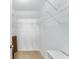 Spacious walk-in closet with ample shelving and storage space, offering organization solutions at 1709 Betrillo Ct, The Villages, FL 32162