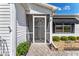 Welcoming screened entrance features decorative ironwork and meticulously maintained landscaping at 1709 Betrillo Ct, The Villages, FL 32162