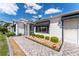 Inviting exterior showcases manicured landscaping, charming awnings, and a paved walkway at 1709 Betrillo Ct, The Villages, FL 32162