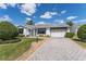 Charming single-story home featuring a paved driveway, well-maintained landscaping, and a delightful curb appeal at 1709 Betrillo Ct, The Villages, FL 32162