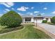 Lovely single-story home boasting manicured landscaping, a paved driveway, and a bright, inviting facade at 1709 Betrillo Ct, The Villages, FL 32162