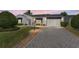 Charming single-story home featuring a paved driveway, well-maintained landscaping, and a delightful curb appeal at 1709 Betrillo Ct, The Villages, FL 32162