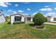 Quaint single-story home featuring a well-manicured lawn and simple landscaping, giving it a cozy feel at 1709 Betrillo Ct, The Villages, FL 32162