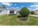 Quaint single-story home featuring a well-manicured lawn and simple landscaping, giving it a cozy feel at 1709 Betrillo Ct, The Villages, FL 32162