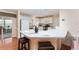 Bright kitchen with white cabinetry, stainless steel appliances and a breakfast bar with seating at 1709 Betrillo Ct, The Villages, FL 32162