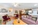 Bright living room with hardwood floors, seamlessly connected to the dining and kitchen areas at 1709 Betrillo Ct, The Villages, FL 32162