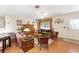 Inviting living room featuring hardwood floors, cozy furniture, and ample natural light at 1709 Betrillo Ct, The Villages, FL 32162