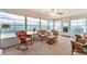 Inviting sunroom featuring wicker furniture, offering a relaxing space with natural light at 1709 Betrillo Ct, The Villages, FL 32162