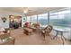 Bright sunroom with wicker furniture, lots of light from large windows, and a ceiling fan at 1709 Betrillo Ct, The Villages, FL 32162