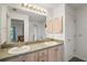 Bathroom featuring double sinks, large vanity, and updated lighting fixtures at 17238 Se 94Th Coults Cir, The Villages, FL 32162