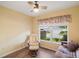 Inviting bedroom space with chair, daybed, window and ceiling fan at 17238 Se 94Th Coults Cir, The Villages, FL 32162