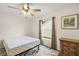 Bright bedroom featuring a ceiling fan, natural light, and stylish decor at 17238 Se 94Th Coults Cir, The Villages, FL 32162