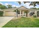 Charming single-story home with a well-manicured lawn and inviting two-car garage at 17238 Se 94Th Coults Cir, The Villages, FL 32162