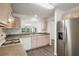 Open kitchen layout with stainless steel appliances, modern cabinetry, and eat-in nook at 17238 Se 94Th Coults Cir, The Villages, FL 32162