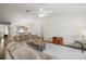 Bright living room with high ceilings, a fan, and a view into the dining area at 17238 Se 94Th Coults Cir, The Villages, FL 32162