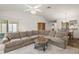 Spacious living room with white walls, a white ceiling fan, and a view of the backyard at 17238 Se 94Th Coults Cir, The Villages, FL 32162