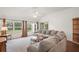Well-lit living room featuring a sectional sofa and multiple windows with natural light at 17238 Se 94Th Coults Cir, The Villages, FL 32162