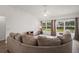 Comfortable living room featuring a plush sectional sofa and large windows at 17238 Se 94Th Coults Cir, The Villages, FL 32162