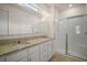 Bathroom featuring double sinks, granite countertop and a glass enclosed shower at 17386 Blazing Star Cir, Clermont, FL 34714