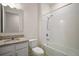 Bright bathroom featuring granite countertop vanity and shower over a bathtub at 17386 Blazing Star Cir, Clermont, FL 34714