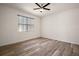 Bedroom with a ceiling fan and a bright window with stylish blinds at 17386 Blazing Star Cir, Clermont, FL 34714