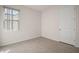 Bright bedroom with a neutral color palette, tile flooring, natural light, and closet access at 17386 Blazing Star Cir, Clermont, FL 34714