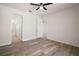 Bedroom with wood flooring and multiple doorways leading to other rooms at 17386 Blazing Star Cir, Clermont, FL 34714